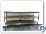The shelving unit is built from 1" X 12" reclaimed spruce planks. The steel frame is fabricated from 1" square steel tubing.